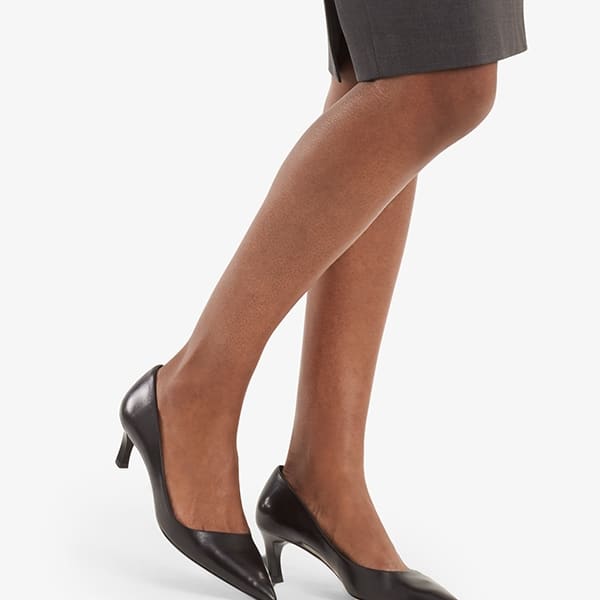Alt grid image of a woman standing wearing the Cobble Hill skirt in gray melange. | Exclude