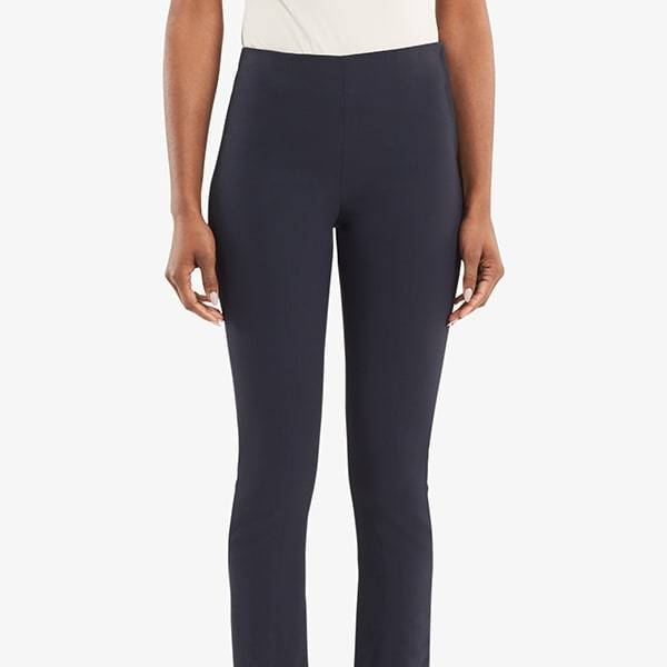 Front grid image of woman standing wearing the Foster pant in dark navy. | Exclude