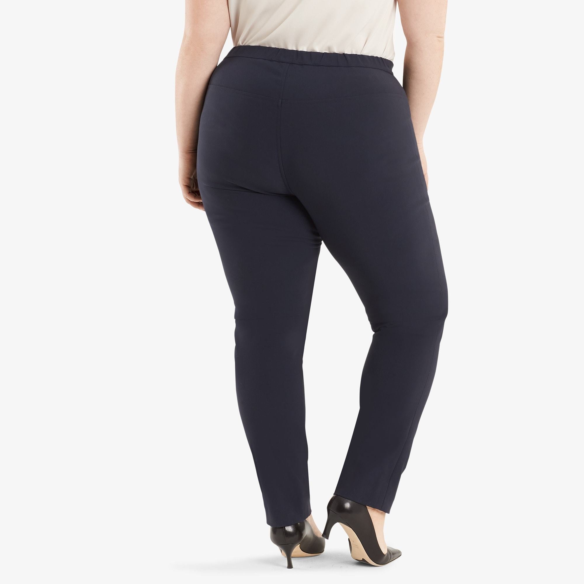 Back image of a woman standing wearing the Foster pant in dark navy. | Exclude