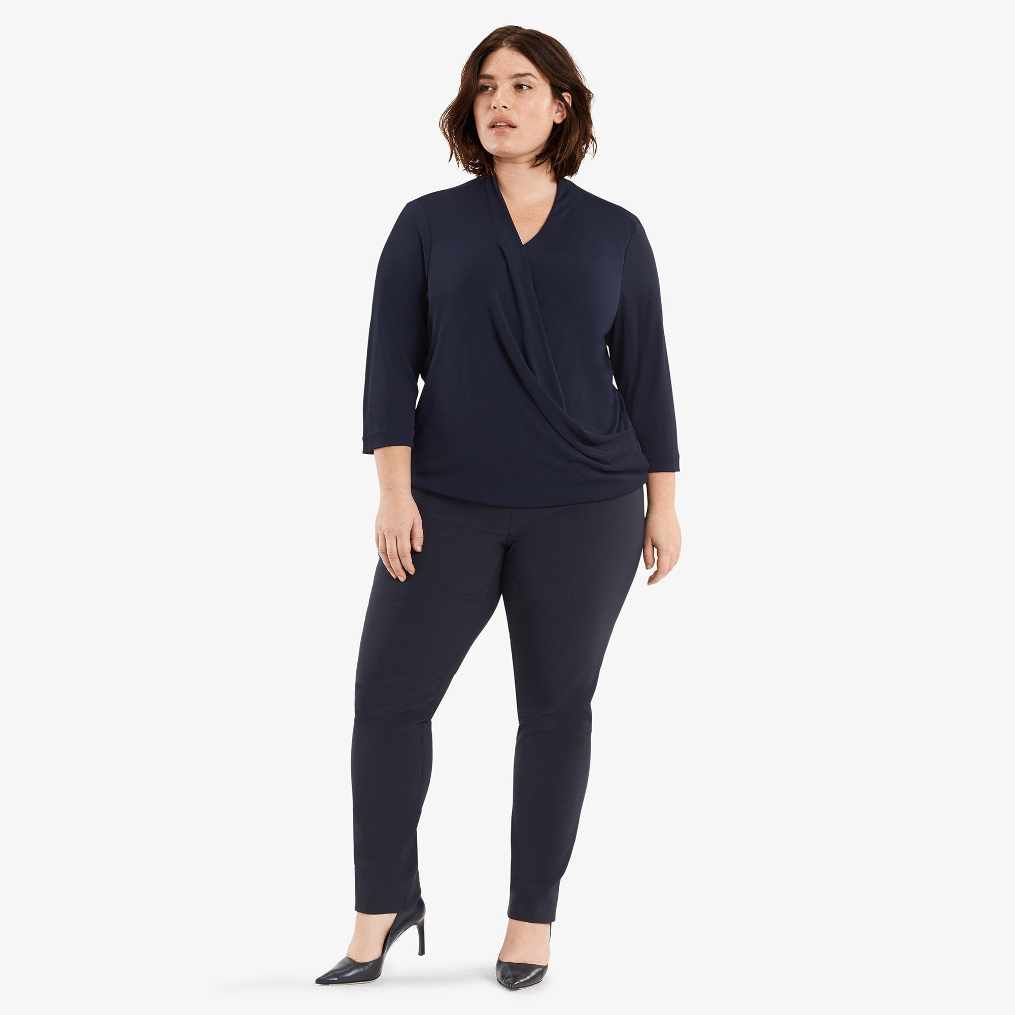 Hero image of a plus size woman posing wearing the Foster pant in dark navy and the Deneuve shirt in galaxy blue | Exclude