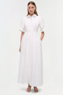 White cotton shirt dress with half sleeves, collared neckline, front button closure, and ankle-length A-line skirt with side 