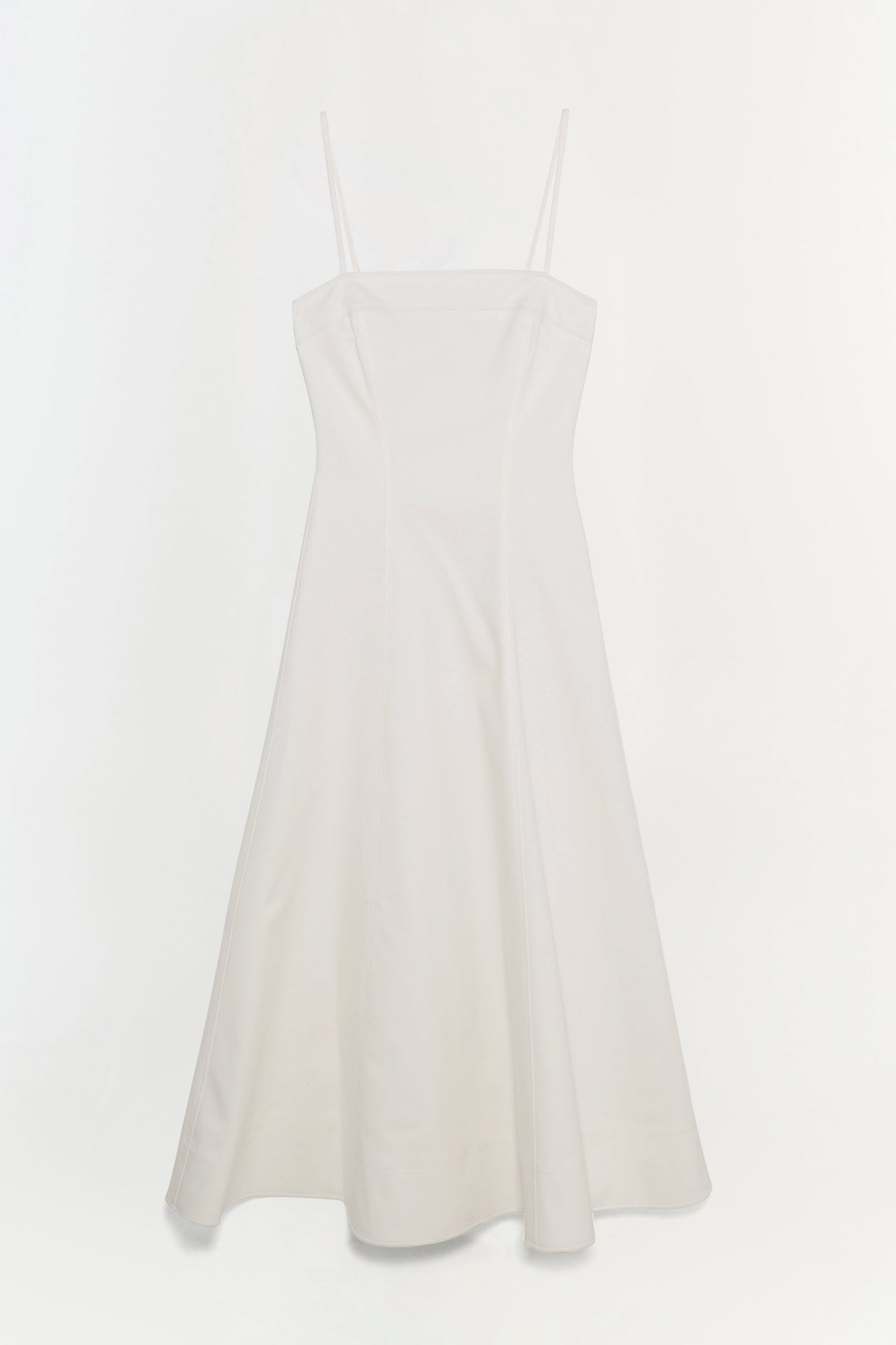 White cotton midi dress with thin shoulder straps and a fitted bodice flowing to a full skirt.