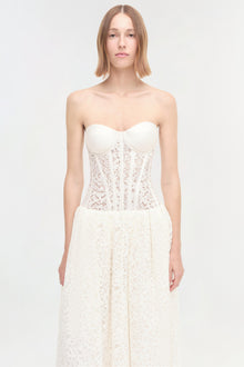 White strapless dress with sweetheart neckline, embellished corset bodice, and lace skirt.