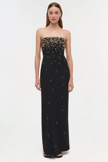 Black strapless gown with gold beading concentrated at the bodice, tapering down the skirt.