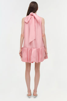Pink sleeveless mini dress with bow tie neckline and gathered ruffle hem, shown from back view.