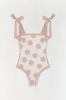 Beige one-piece swimsuit with tan polka dots and tied shoulder straps.
