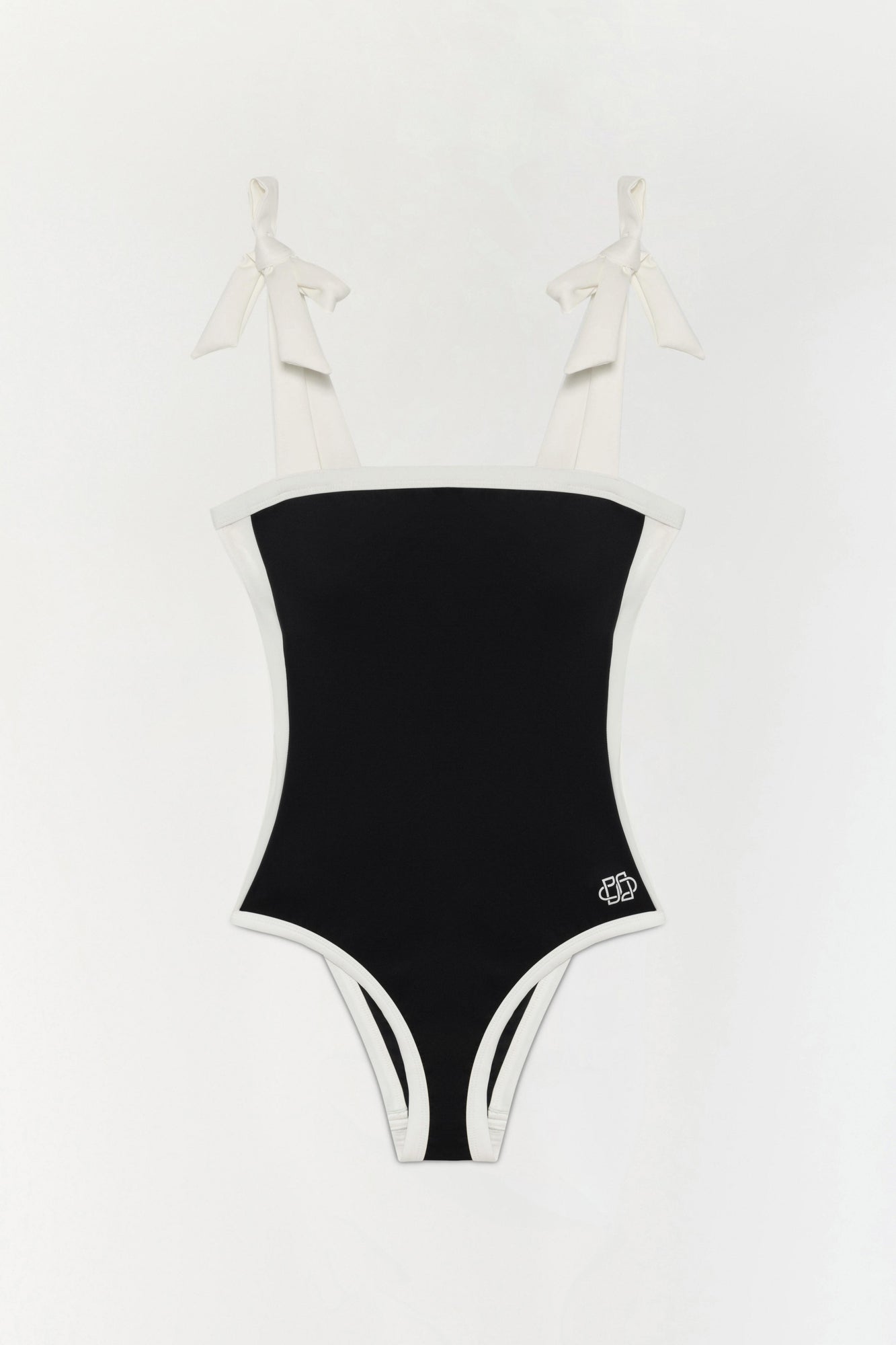 Black and white colorblocked one-piece swimsuit with bow shoulder straps and a small logo on the hip.