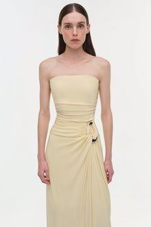 Cream strapless gown with draped ruching at the bodice and gathered side detail with decorative hardware.