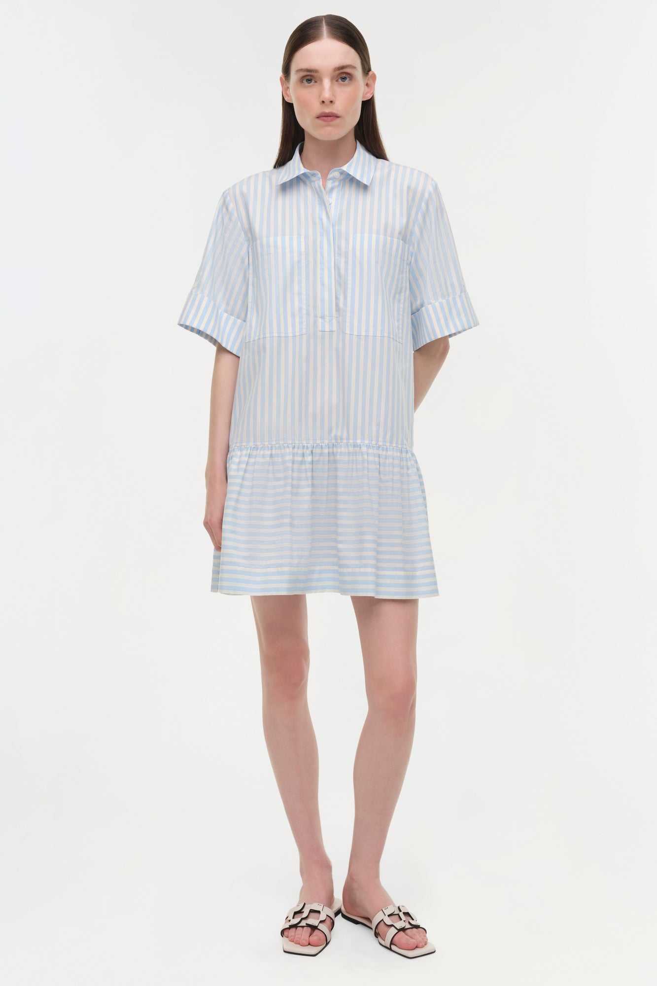 Light blue and white striped cotton shirt dress with short sleeves, button front, and gathered skirt hem.