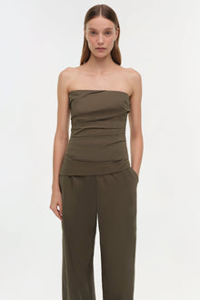 Olive green strapless top with horizontal ruching across the torso and matching wide-leg pants.