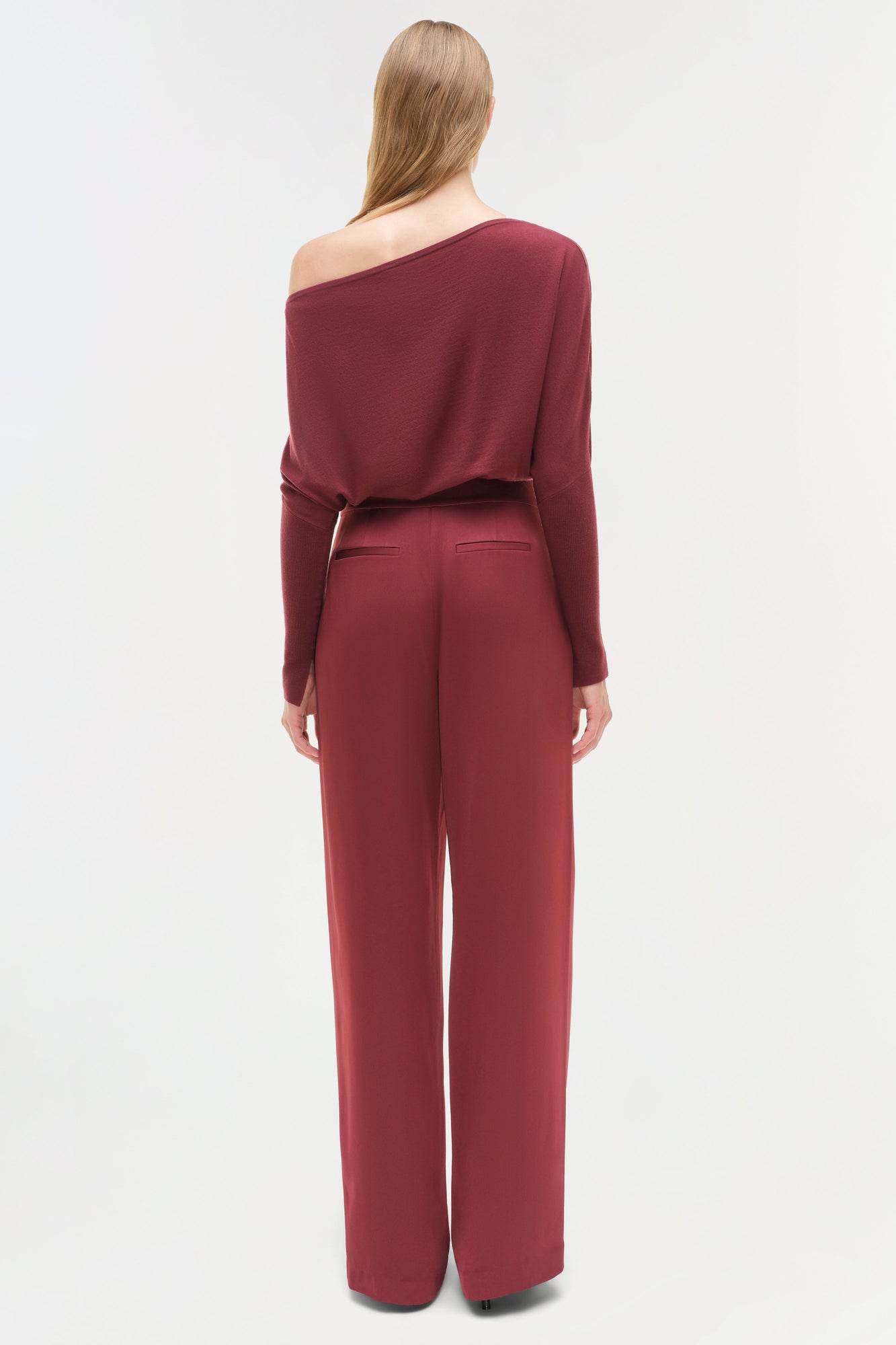 Burgundy off-shoulder sweater with long sleeves and matching high-waisted wide-leg pants, shown from back view.