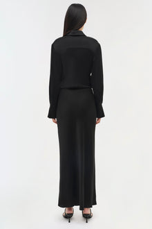 Black long-sleeve collared dress with a fitted bodice and flowing maxi skirt, shown from back view.