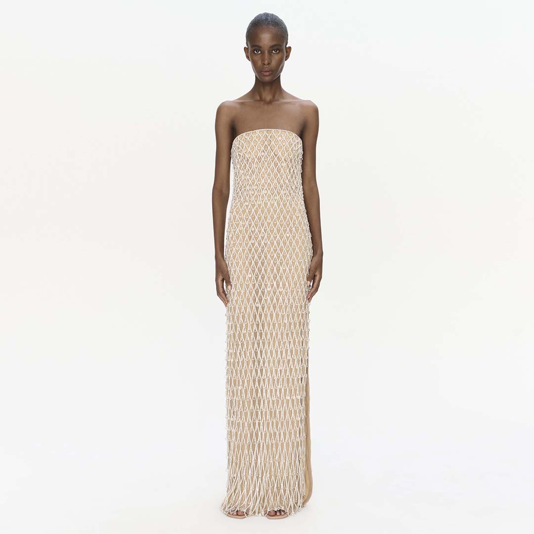 Strapless beige mesh maxi dress with all-over diamond pattern and fringe hem.