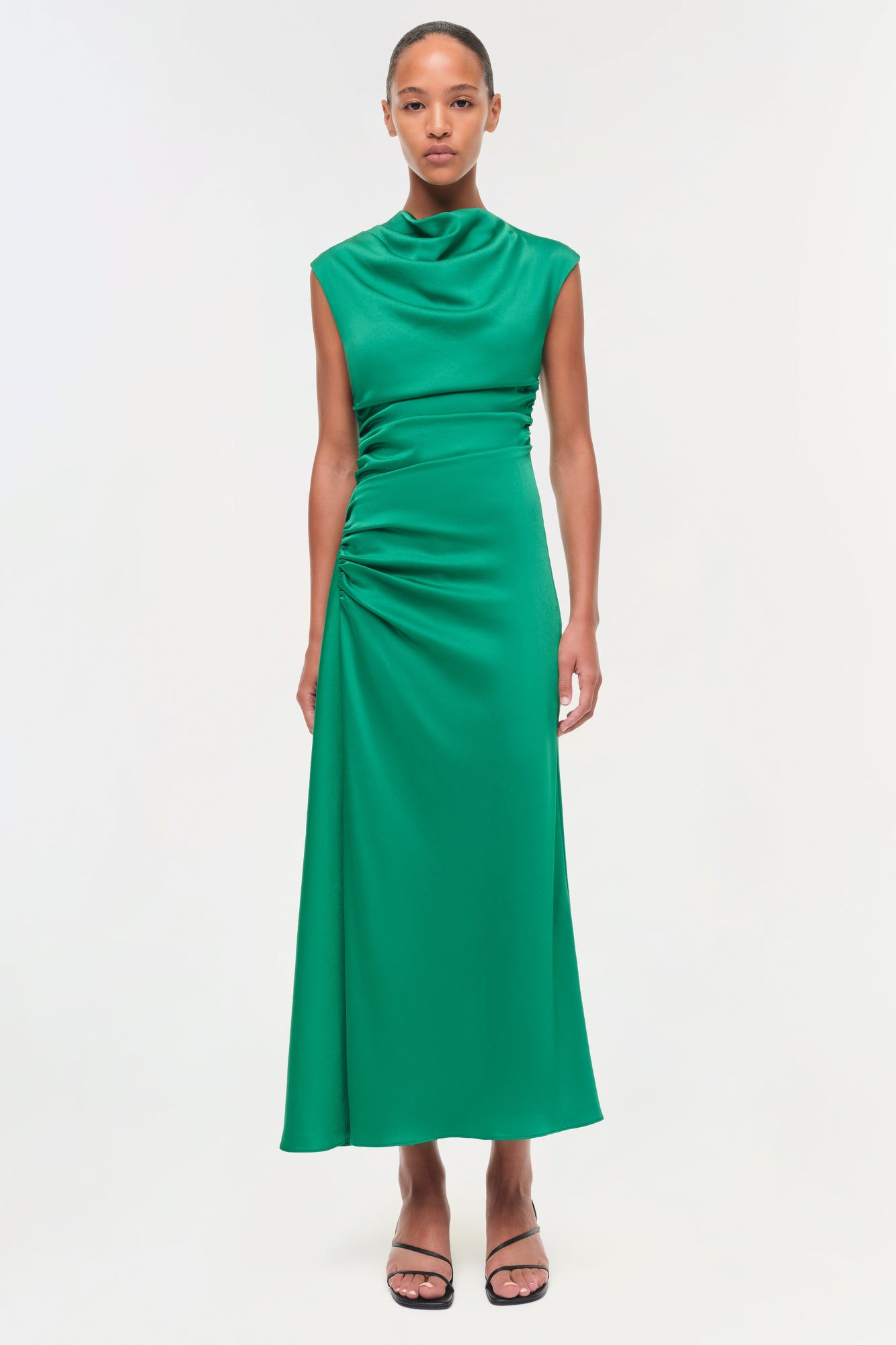 Green satin midi dress with draped neckline and ruched side detailing, sleeveless design.