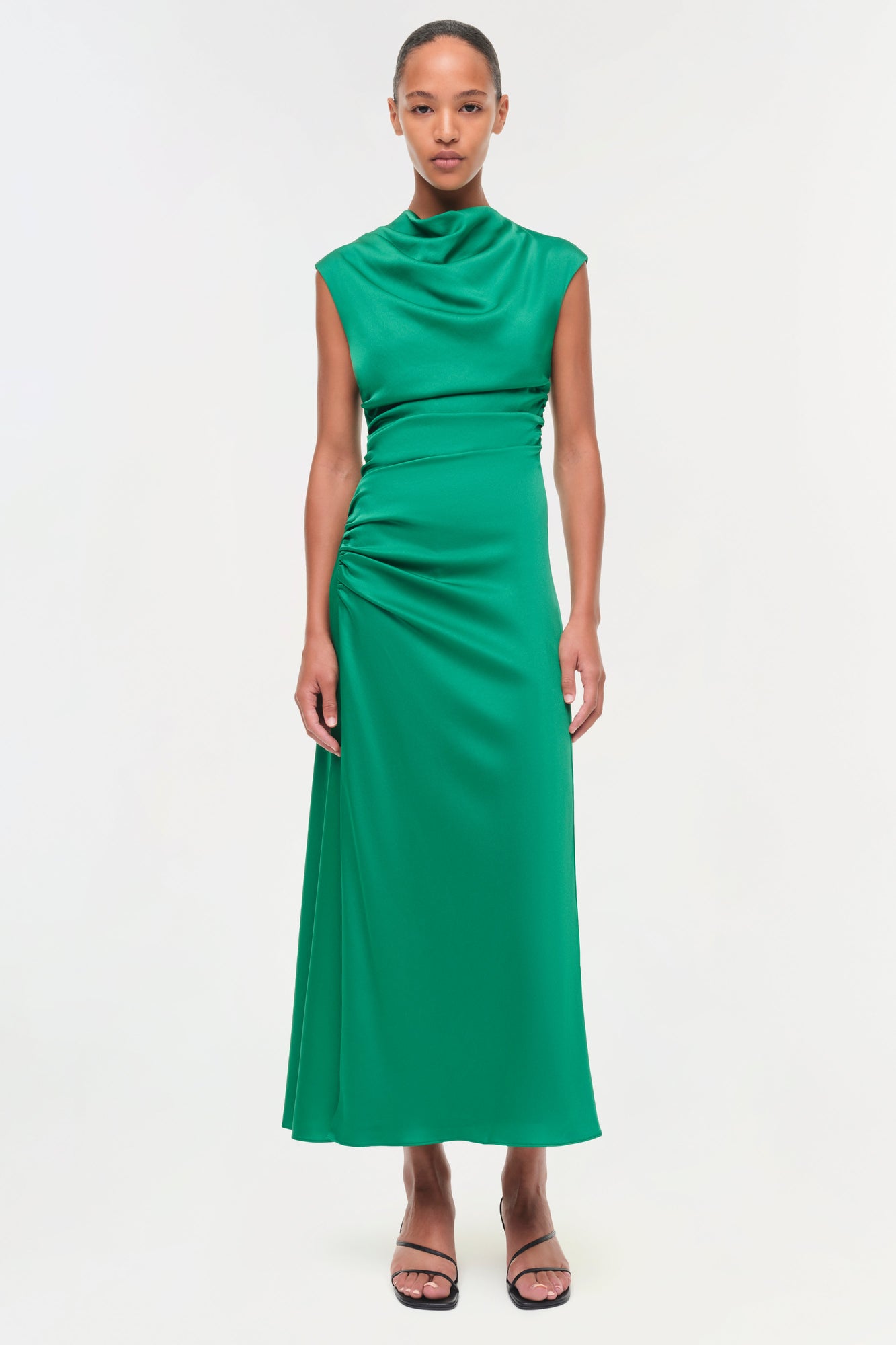 Green satin midi dress with draped cowl neckline, ruched waist, and sleeveless design.