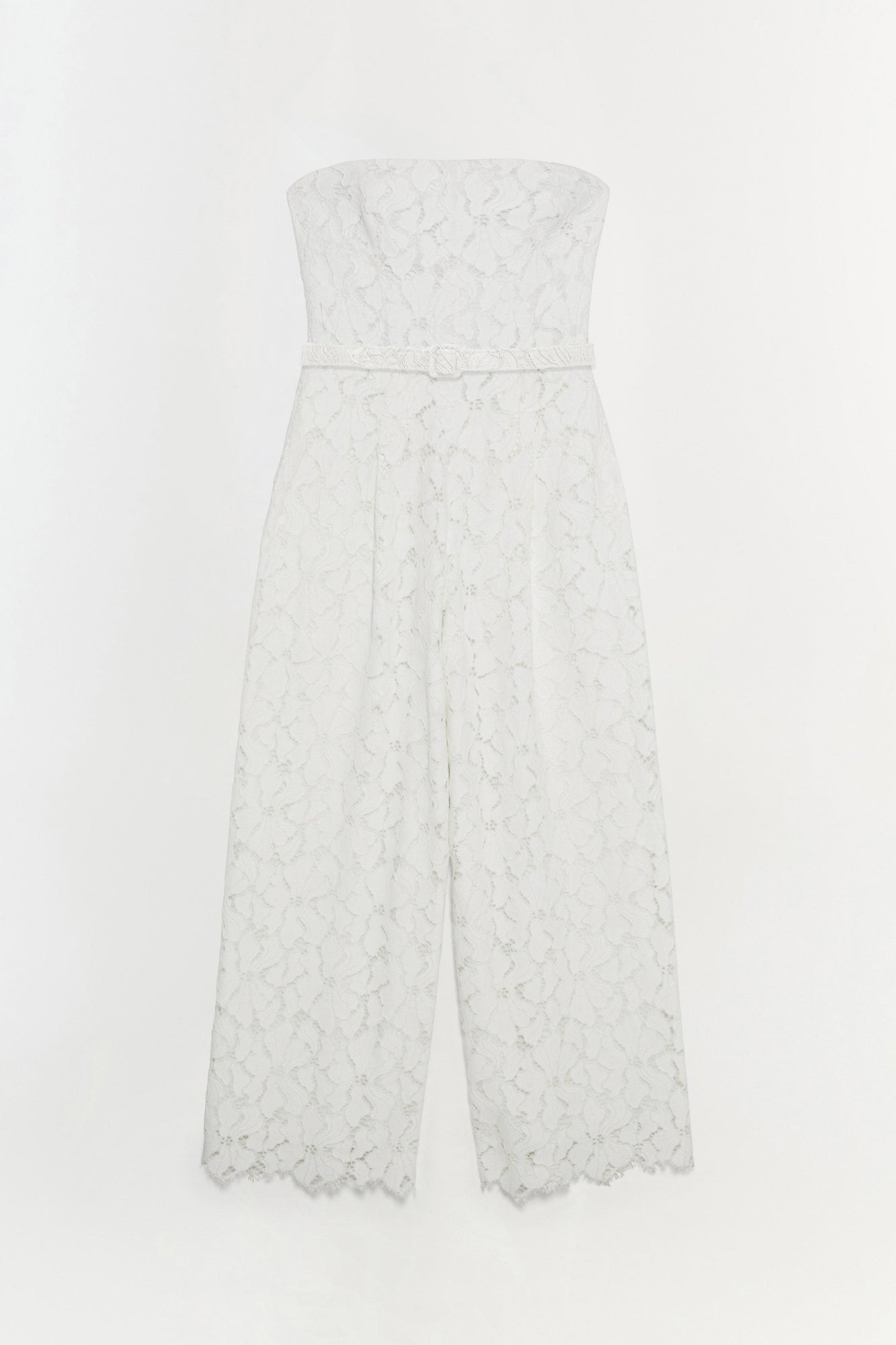 White lace strapless jumpsuit with a belted waist and wide-leg cropped pants with scalloped hem.