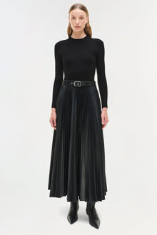 Black knit midi dress with long sleeves, pleated skirt, and belted waist worn with black boots.