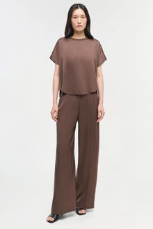 Brown satin t-shirt with short sleeves and crew neckline worn with matching wide-leg satin pants.