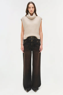 Black denim jeans with dual waistband detail and wide-leg fit, shown on model with cream sleeveless turtleneck.