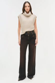 Black denim jeans with double waistband detail, styled with cream sleeveless turtleneck sweater.