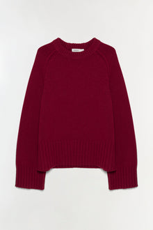 Burgundy crewneck sweater with ribbed texture and cuffed sleeves.