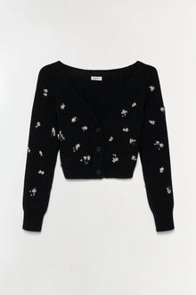 Black ribbed knit cardigan with scattered silver floral embellishments and black button front closure.