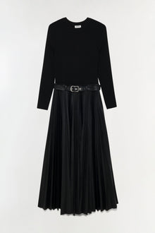 Black midi dress with long sleeves, knit top, pleated skirt, and black belted waist.