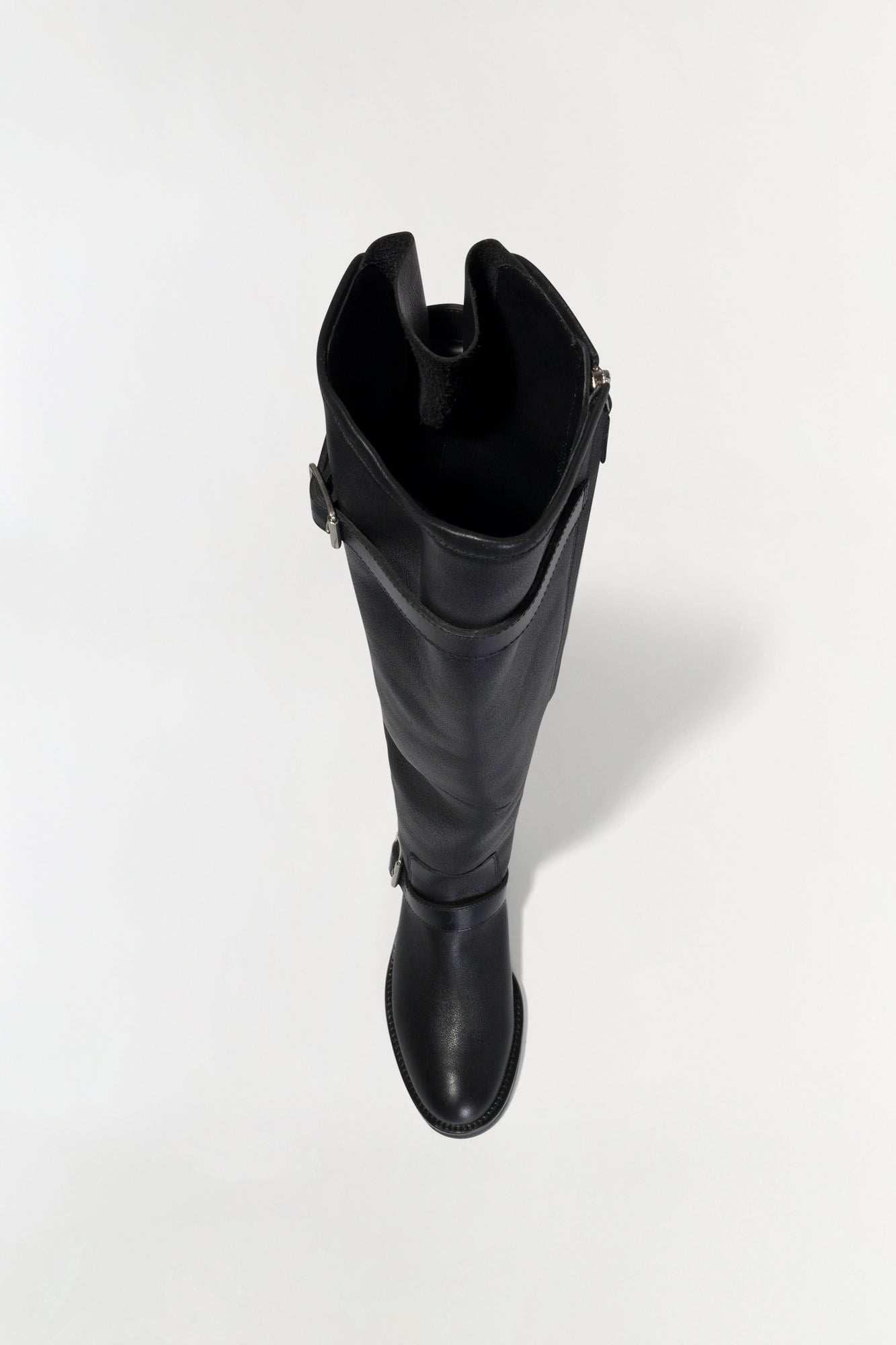 Black leather over-the-knee boot with buckle straps on the side, shown from above against a white background.