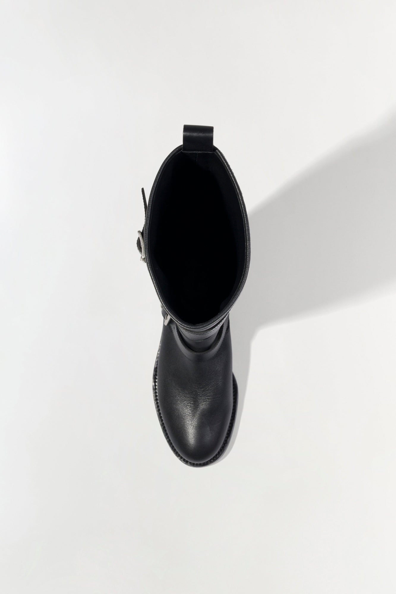 Black leather moto boot with buckle strap detail, shown from top view.