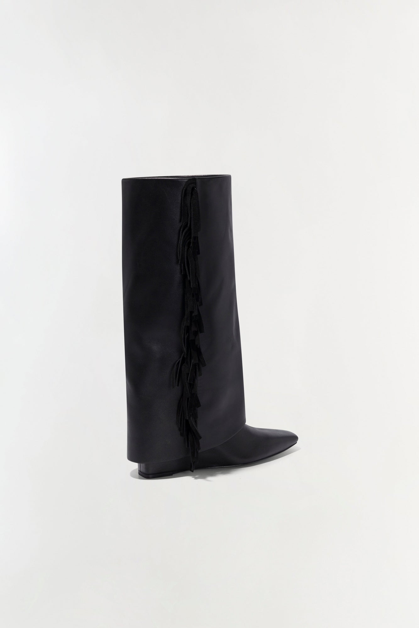 Black leather knee-high boot with fringe trim down the side seam and flat heel.