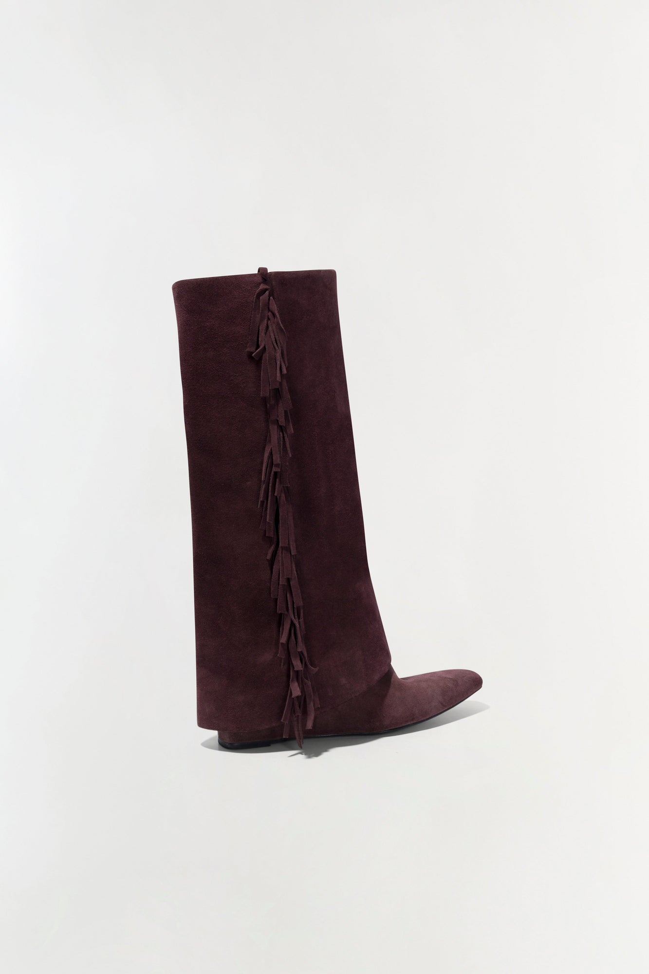 Burgundy suede knee-high boot with fringe trim running down the back seam.