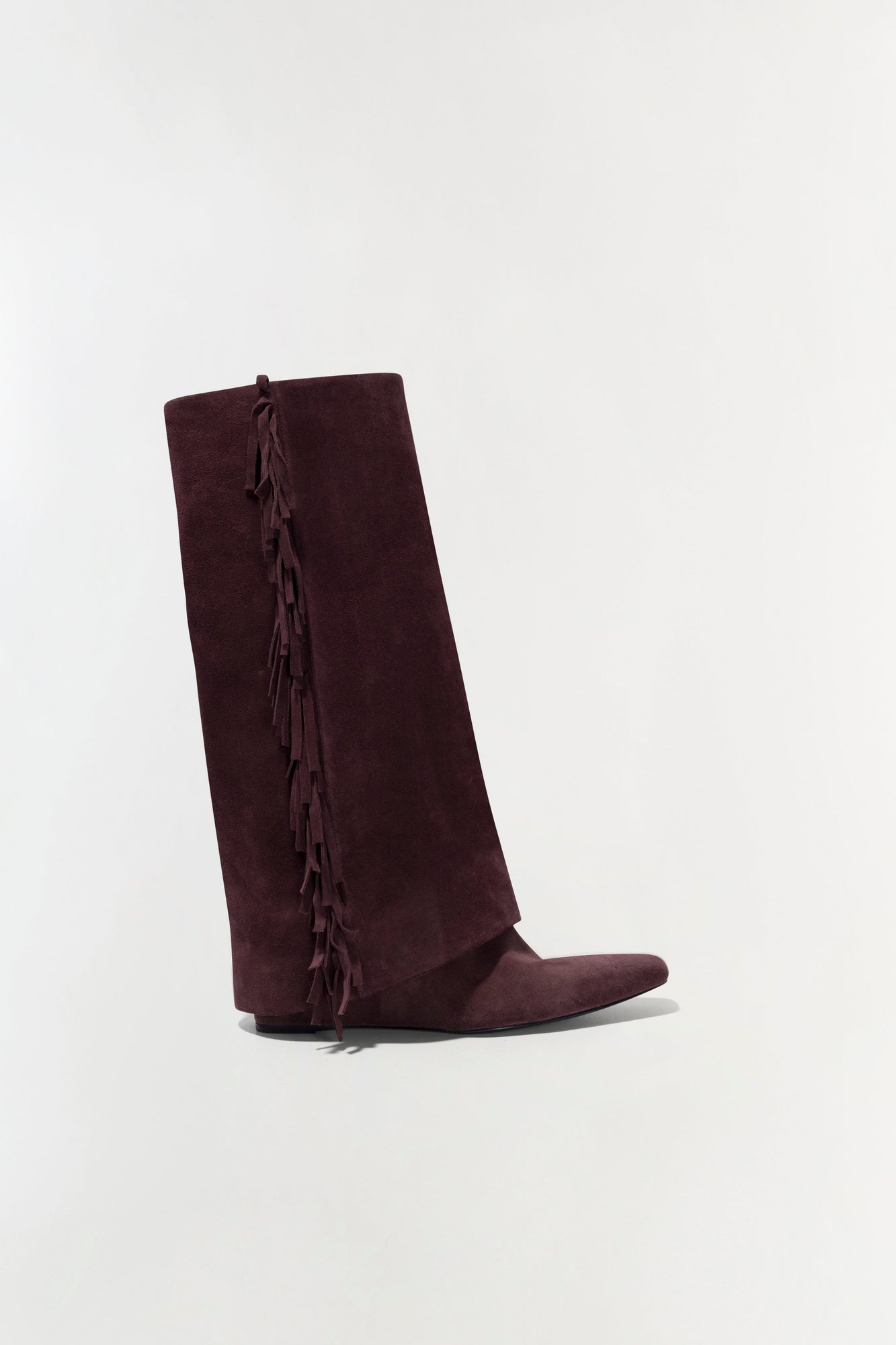 Burgundy suede knee-high boot with fringe trim down the side seam, shown in profile view.