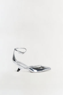 Silver metallic pointed-toe wedge with ankle strap and buckle closure, shown in profile view.