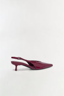 Burgundy patent leather slingback heel with pointed toe and thin kitten heel, shown in side profile.