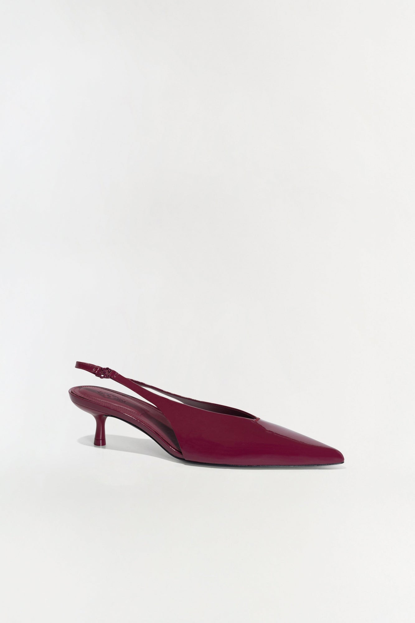 Burgundy slingback kitten heel with pointed toe and adjustable heel strap.