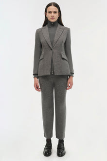 Gray wool blazer with notch lapels worn with matching ribbed turtleneck and cropped trousers.