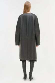 Dark gray leather coat worn over black lace dress, shown from back with matching knee-high black leather boots.