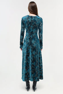 Teal velvet midi dress with black floral pattern, long sleeves, and fitted bodice, shown from back.