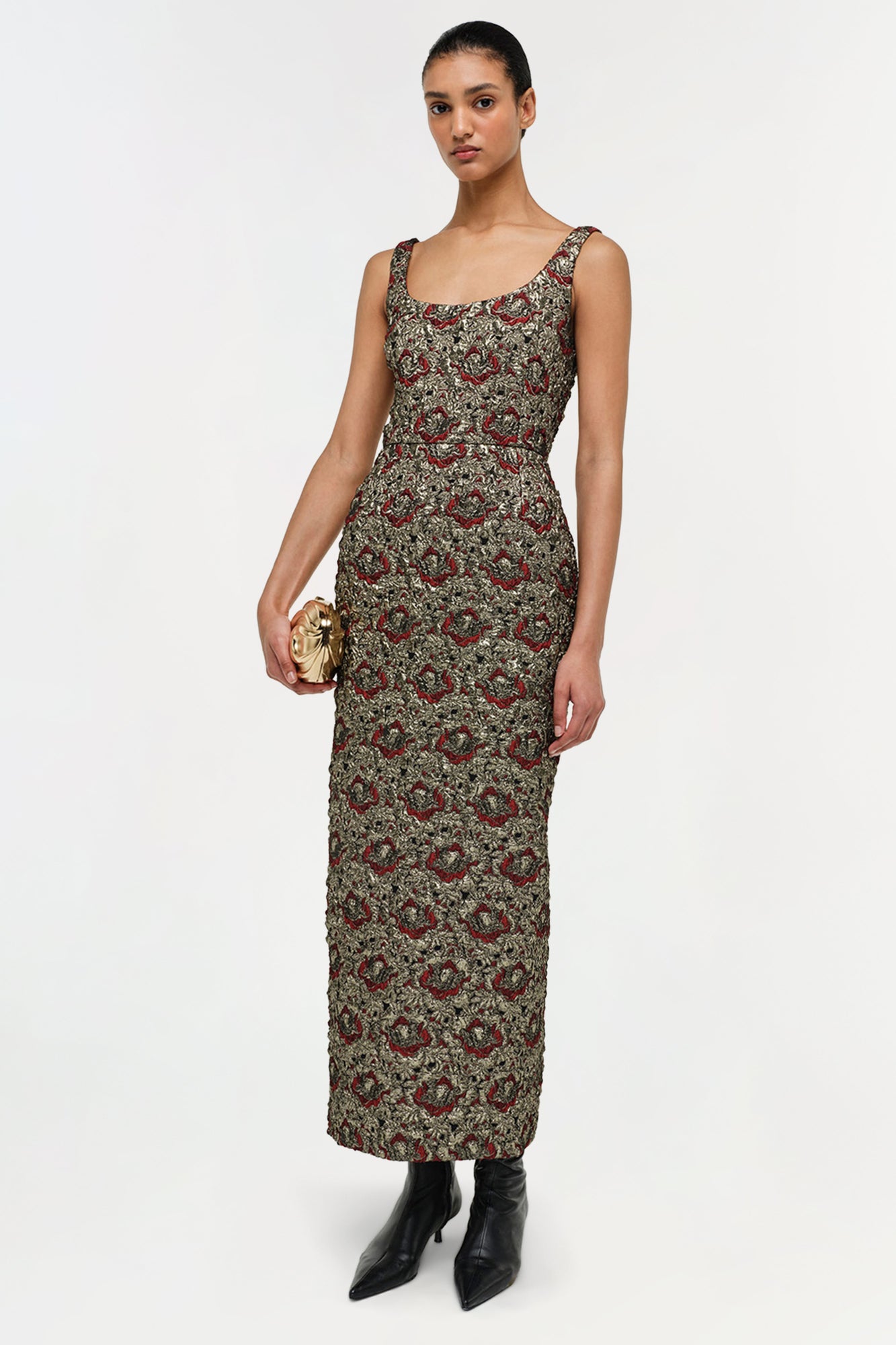 Sleeveless midi dress with gold and red floral jacquard pattern on olive background, scoop neckline, fitted waist.