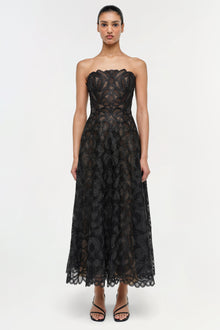 Black strapless lace midi dress with geometric pattern and scalloped hem.