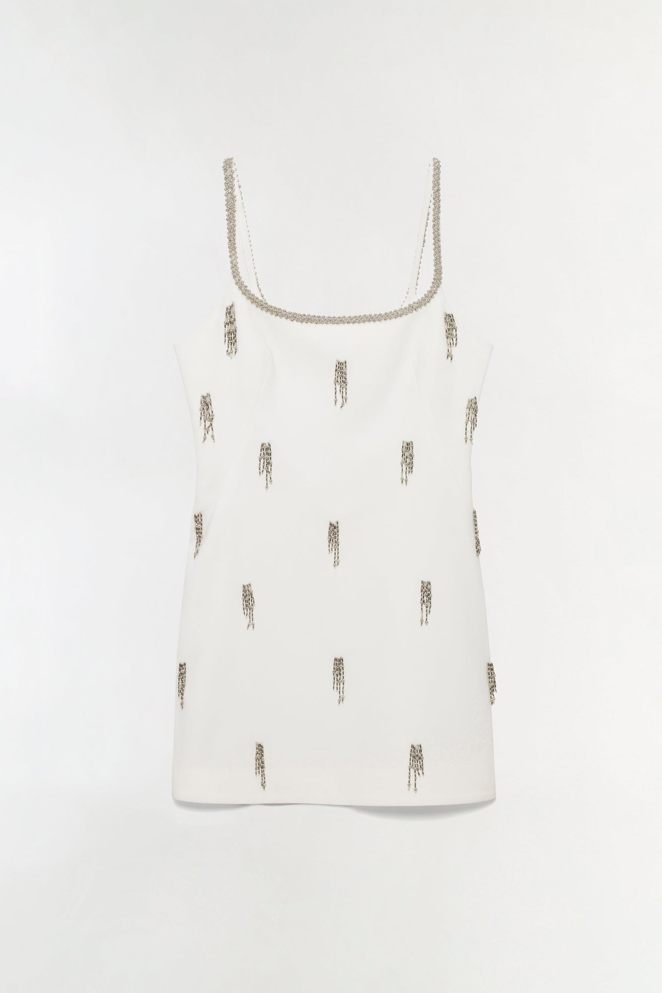 White sleeveless mini dress with beaded neckline and scattered beaded fringe embellishments throughout.