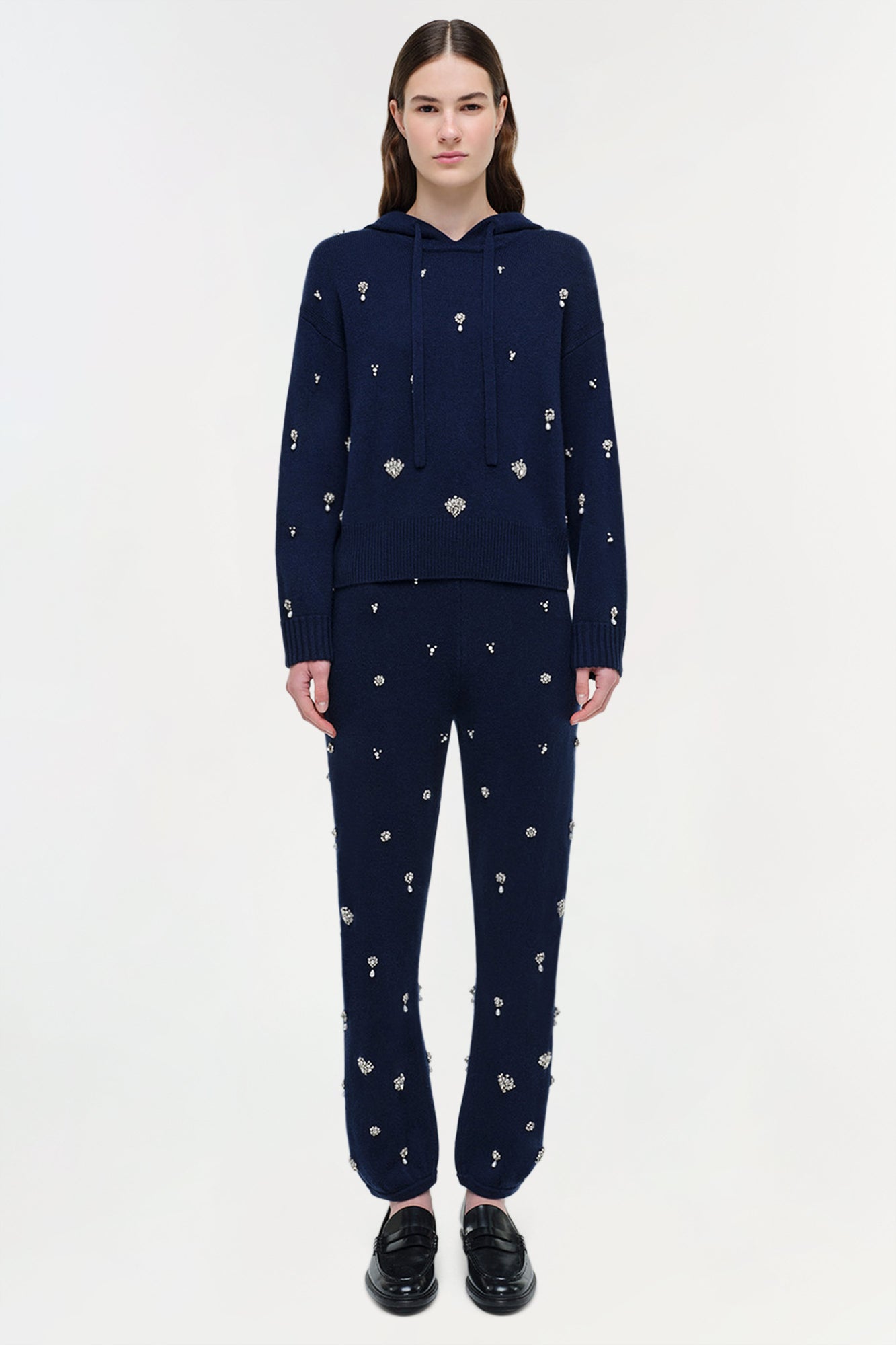Navy cashmere hoodie with scattered crystal embellishments, paired with matching embellished pants.