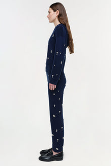 Navy cashmere hoodie with scattered rhinestone embellishments throughout, shown on model with matching leggings.