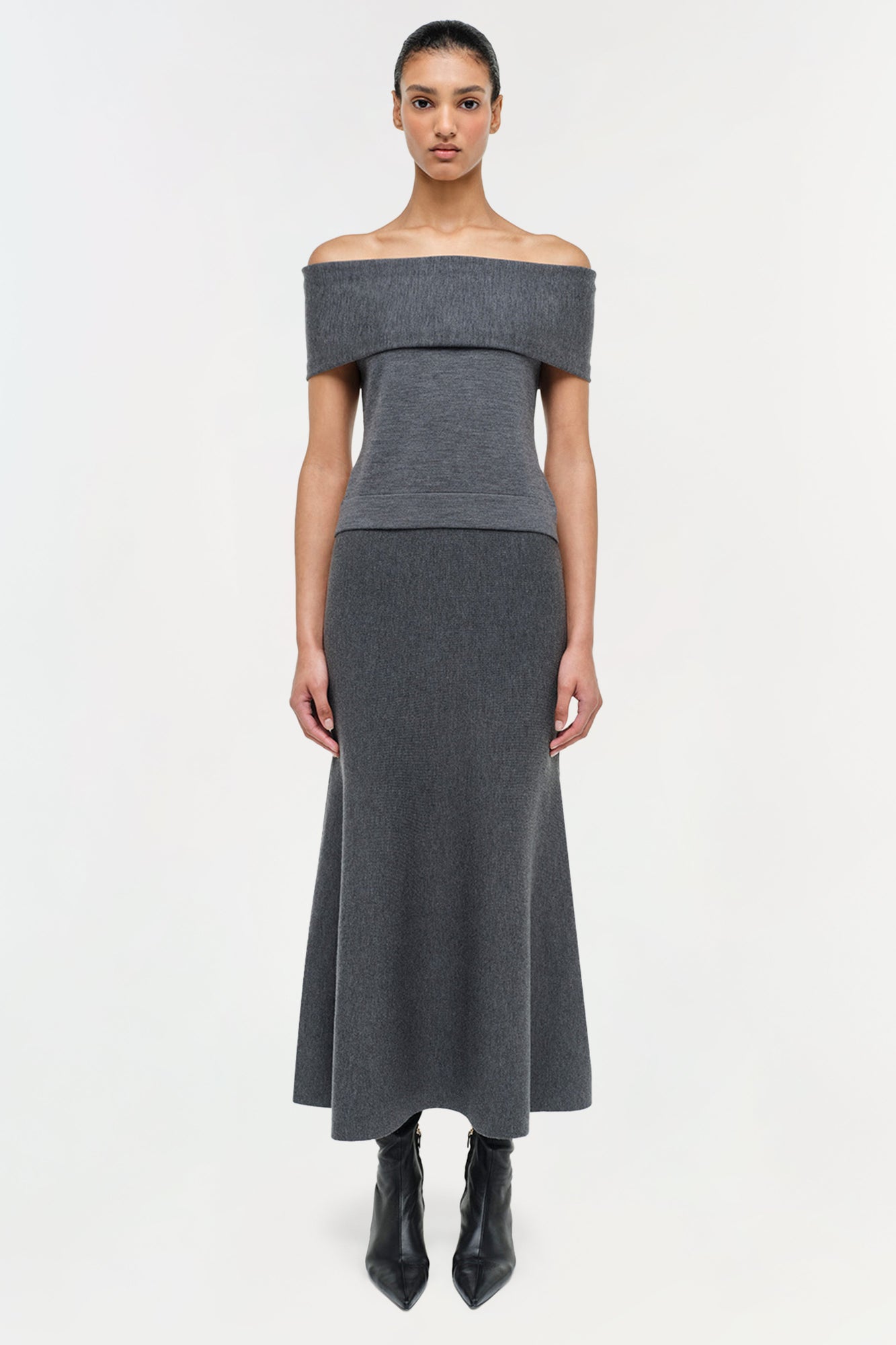 Charcoal gray wool off-shoulder top with short sleeves and fitted waist, shown on model with matching midi skirt.