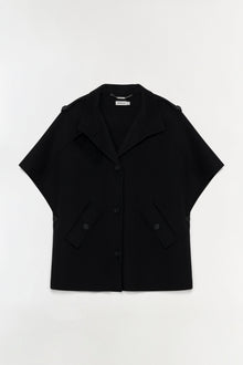 Black wool cape jacket with notched collar, short sleeves, front button closure, and patch pockets.