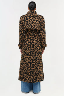 Leopard print wool overcoat with belt detail and rolled cuffs, worn over blue jeans.