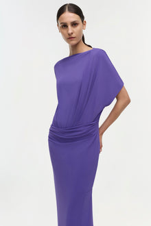 Purple gown with short dolman sleeves and ruched waist detail at hip.