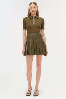 Olive-toned mini dress with ribbed knit polo top, half-zip closure, and pleated skirt with belt detail.