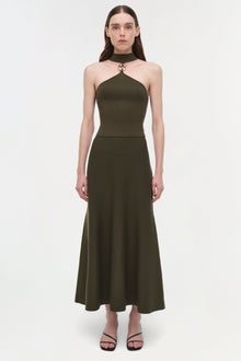 Olive green wool midi skirt with A-line silhouette and high waistband, worn with matching halter top.