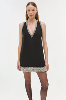 Black sleeveless halter mini dress with silver beaded trim on neckline and hem.
